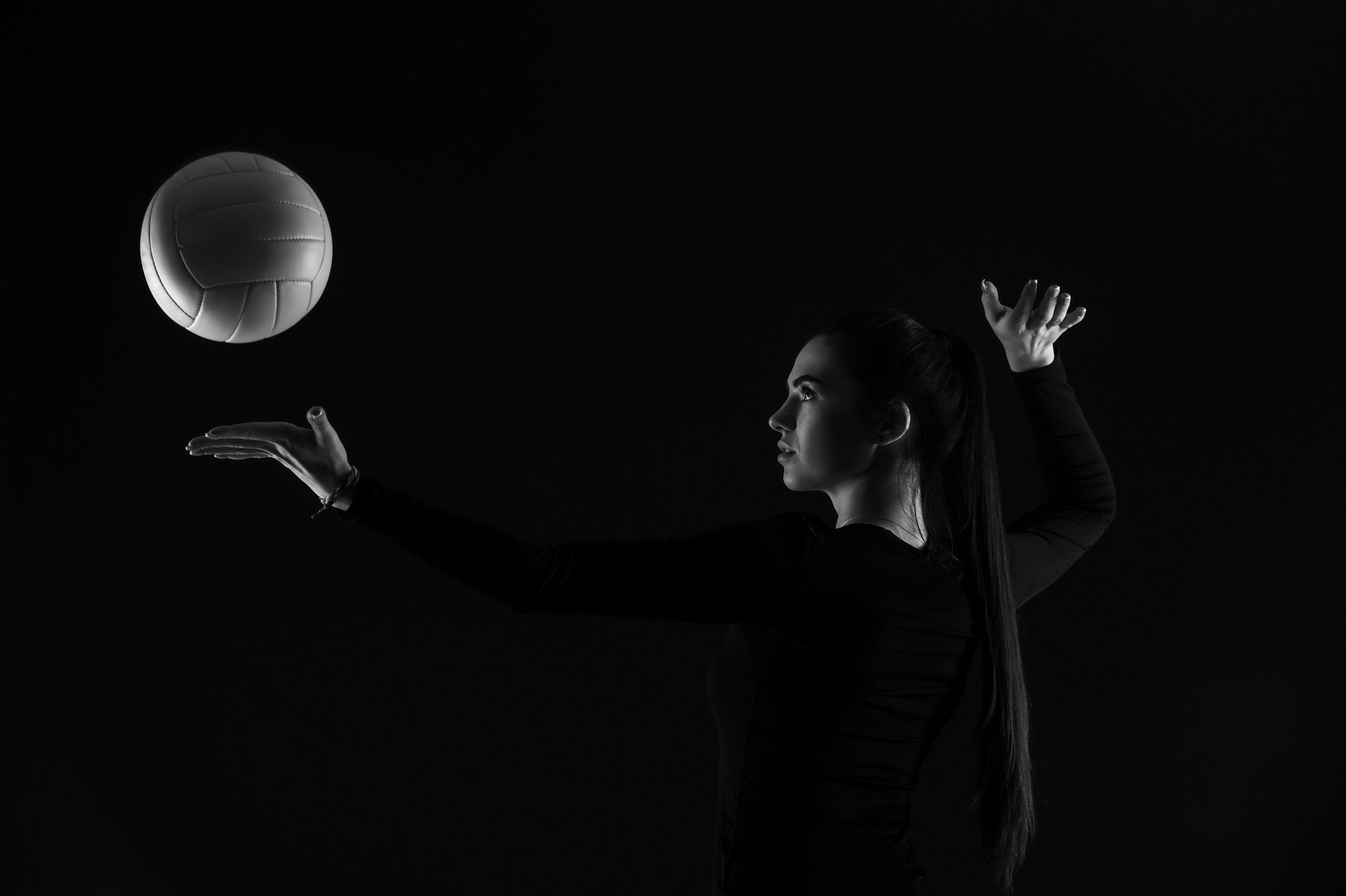 Woman Playing Volleyball on Dark Background